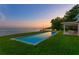 Sparkling in-ground pool set in a lush green yard with scenic water views at 218 Colony Point S Rd, St Petersburg, FL 33705