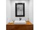 Stylish powder room featuring a wood counter with a square basin sink and modern black faucet at 218 Colony Point S Rd, St Petersburg, FL 33705