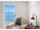 Comfortable sitting area with water views through a large window and a stylish table lamp at 218 Colony Point S Rd, St Petersburg, FL 33705