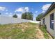 Spacious back yard with a white fence and lush green grass, perfect for outdoor activities at 27050 Anthony Ave, Brooksville, FL 34602