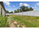 Spacious back yard with a white fence and lush green grass, perfect for outdoor activities at 27050 Anthony Ave, Brooksville, FL 34602
