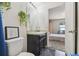 Bright bathroom featuring a toilet, vanity, and an open view into the bedroom at 27050 Anthony Ave, Brooksville, FL 34602