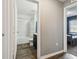 View from the hall of the bathroom with shower and a bedroom at the end of the hall at 27050 Anthony Ave, Brooksville, FL 34602