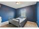 Blue bedroom featuring a single bed and a window at 27050 Anthony Ave, Brooksville, FL 34602