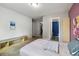 Neutral bedroom featuring a bed, bench, walk-in closet, and ensuite bathroom at 27050 Anthony Ave, Brooksville, FL 34602