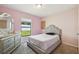 Bedroom featuring a vanity with a mirror and a bed with decorative headboard at 27050 Anthony Ave, Brooksville, FL 34602