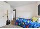 View of bedroom with neutral carpet, door to hall, and bed with dinosaur comforter at 27050 Anthony Ave, Brooksville, FL 34602