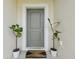 Inviting front entrance with a stylish door, a decorative rug, and potted plants at 27050 Anthony Ave, Brooksville, FL 34602
