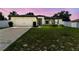 Charming single-story home featuring a two-car garage, manicured lawn, and tasteful landscaping at 27050 Anthony Ave, Brooksville, FL 34602