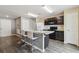 Bright kitchen features dark cabinetry, a breakfast bar with seating, and modern appliances at 27050 Anthony Ave, Brooksville, FL 34602