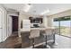 Bright kitchen boasts breakfast bar seating and stainless sink below an integrated dual light fixture at 27050 Anthony Ave, Brooksville, FL 34602