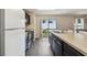 A kitchen with a stainless steel sink, dark cabinets, and a window to the outdoors at 27050 Anthony Ave, Brooksville, FL 34602