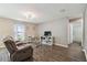 Cozy living room with a comfortable reclining sofa and views into the bathroom at 27050 Anthony Ave, Brooksville, FL 34602