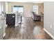 Open-concept living area featuring modern flooring, a breakfast bar, and a comfortable recliner at 27050 Anthony Ave, Brooksville, FL 34602