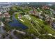 Overhead view of a golf course with ponds, bunkers, and scenic fairways winding through a lush, green landscape at 2773 Seabreeze S Dr, Gulfport, FL 33707