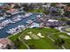 Overhead view of a marina with numerous boats, a clubhouse with a pool, and a beautifully landscaped golf course at 2773 Seabreeze S Dr, Gulfport, FL 33707