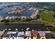 Beautiful aerial perspective of waterfront residences with private docks and boat slips, alongside manicured golf course at 2773 Seabreeze S Dr, Gulfport, FL 33707