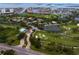 Aerial view capturing the essence of a golf community with manicured courses, serene ponds, and lush landscaping in a residential area at 2773 Seabreeze S Dr, Gulfport, FL 33707