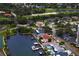 Aerial view of waterfront homes with boat docks, pools, golf course and lush landscaping, combining luxury and leisure at 2773 Seabreeze S Dr, Gulfport, FL 33707