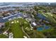 Aerial shot showcasing a golf course and marina with various amenities and waterfront homes, ideal for leisure and recreation at 2773 Seabreeze S Dr, Gulfport, FL 33707