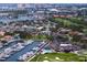 Scenic aerial view of a marina with numerous boats, a country club with a pool, and a meticulously maintained golf course at 2773 Seabreeze S Dr, Gulfport, FL 33707