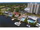 Aerial view showcasing waterfront homes with private pools and docks near a condo building at 2773 Seabreeze S Dr, Gulfport, FL 33707