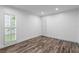 Bright bedroom with shuttered window and wood-look flooring at 2773 Seabreeze S Dr, Gulfport, FL 33707