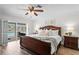 Well-lit bedroom with elegant furnishings, wood-look floors, and sliding glass doors to the patio at 2773 Seabreeze S Dr, Gulfport, FL 33707