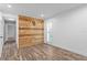 Bright bedroom featuring stylish wood-look floors, custom wood wall paneling, and ample natural light at 2773 Seabreeze S Dr, Gulfport, FL 33707