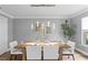 Formal dining room with modern lighting, elegant table setting, and neutral wall color at 2773 Seabreeze S Dr, Gulfport, FL 33707