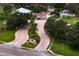 Scenic community entrance with lush landscaping, mature trees, and a welcoming gatehouse at 2773 Seabreeze S Dr, Gulfport, FL 33707