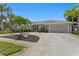 Well-maintained single-Gathering home with circular driveway, mature landscaping, and an attached two-car garage at 2773 Seabreeze S Dr, Gulfport, FL 33707