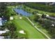 Scenic aerial view of the beautiful golf course featuring lush green fairways and a tranquil water hazard at 2773 Seabreeze S Dr, Gulfport, FL 33707
