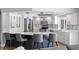 Modern kitchen with a large island, stylish seating, stainless steel appliances, and custom cabinetry at 2773 Seabreeze S Dr, Gulfport, FL 33707