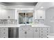 Bright kitchen features white cabinets, stainless steel appliances, and a window with a view to the spa area at 2773 Seabreeze S Dr, Gulfport, FL 33707