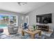 Light and bright living room featuring vaulted ceilings, comfortable seating and views of the pool and waterfront at 2773 Seabreeze S Dr, Gulfport, FL 33707