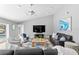 Bright living room with high ceilings, TV, modern furniture, and access to the outdoor pool and patio at 2773 Seabreeze S Dr, Gulfport, FL 33707