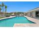 Beautiful outdoor pool featuring deck chairs, a boat dock and tropical landscaping with sunny skies at 2773 Seabreeze S Dr, Gulfport, FL 33707