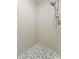Unique shower featuring attractive pebble tile floor, complemented by neutral wall tiles, and modern fixture at 2773 Seabreeze S Dr, Gulfport, FL 33707