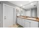 Bathroom featuring a double sink vanity, a large mirror, and tile floors at 2807 Northcote Dr, Palm Harbor, FL 34684