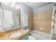 Bright bathroom with tile shower, granite countertop vanity and decorative accents at 2807 Northcote Dr, Palm Harbor, FL 34684