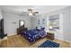 Comfortable bedroom featuring ceiling fan, soft carpet, window with blinds, and a nautical theme at 2807 Northcote Dr, Palm Harbor, FL 34684