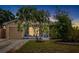 Inviting single-story home featuring a screened porch and well-maintained landscaping at 2807 Northcote Dr, Palm Harbor, FL 34684