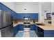 Well-equipped kitchen with stainless steel appliances and blue cabinets at 2807 Northcote Dr, Palm Harbor, FL 34684