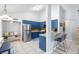 Bright kitchen with blue cabinetry, stainless steel appliances, and breakfast bar seating at 2807 Northcote Dr, Palm Harbor, FL 34684