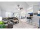 Spacious living room with tile flooring, a comfortable sectional sofa, and views into the dining area at 2807 Northcote Dr, Palm Harbor, FL 34684