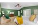 Another view of the spacious main bedroom features green walls, plush carpet, and a cozy lounging area at 2807 Northcote Dr, Palm Harbor, FL 34684