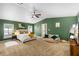 Spacious main bedroom features green walls, plush carpet, a ceiling fan, and lots of natural light at 2807 Northcote Dr, Palm Harbor, FL 34684