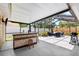 Enclosed patio boasts an outdoor bar, BBQ, ceiling and shaded lounge area at 2807 Northcote Dr, Palm Harbor, FL 34684