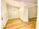 Well-lit dining area with wood floors and a stylish chandelier at 3143 Phoenix Ave, Oldsmar, FL 34677